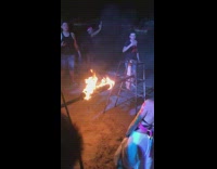 Girl knocks over limbo stick on fire 