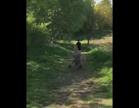 Little boy on bicycle runs into tree