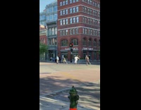 Guys rollerblade down empty street face masks 