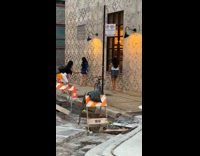 Two influencers sidewalk pattern building wall 