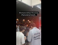 Crowd celebrates 99 cent pizza on street
