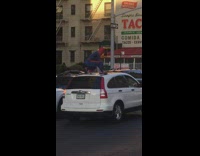 Spiderman costume guy crouches white car roof 