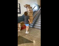 Guy drops tall pile of boxes 