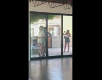 Two girls hug for a photo outside 