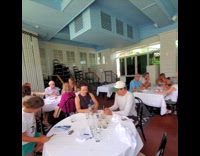 Man fishing a turtle near boathouse patio