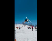 Guy rides skis across lake backflips snow 