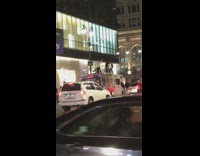 Guys dance on roof of white car
