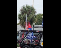 Truck with Trump flags honk at street