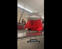 Koolaid man costume on subway escalators 