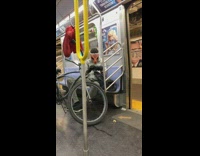 Guy on train wears orange dinosaur mask