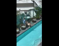 Woman in bikini in chair beside pool