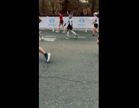 Shirtless guy runs at marathon with sandals