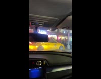 Taxi backs out of street with a lot of traffic 