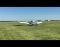 Two white planes long wings fly grass