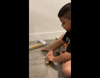 Little boy crying trying to wrap present blue ball 