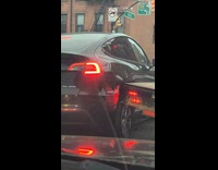 Truck damage side of black Tesla car