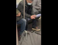 Guy asleep with red white clown mask
