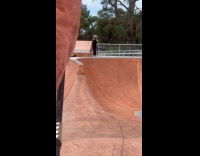Man black shirt scooter trick fails skate park