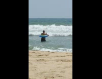 Middle aged man wears floaty to the beach 