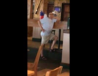 Blue shirt dad poses restaurant united banner