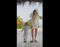 Mom shows outfit with toddler 