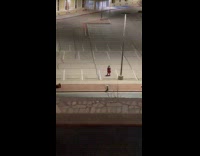 Woman red skirt dances at parking lot