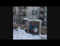 Guy makes fat snowman wearing red mask 