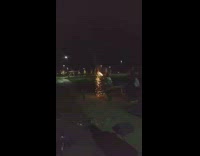 Guy throw firework shooter at each other in the dark and throw it at recorder