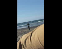 Girl spin around beach hold selfie stick