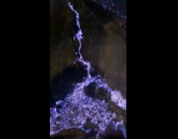 Man shows blue lava coming from volcano