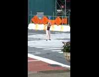 Drunk woman dances and jumps around on crosswalk 
