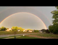 Double rainbow on sky with lightning underneath