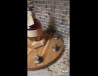 Bottle of whiskey on top of white wood sensor platform