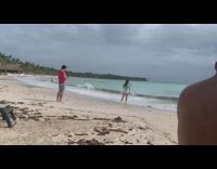 Woman green backless top stand beach overcast