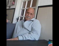 Bald dad sits and laughs slow motion