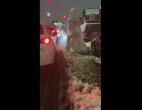 Snowman of woman with kid on street