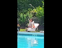 Woman sit chair livestream at poolside ring light