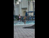 Woman pink skirt pose beside swimming pool