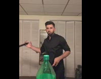 Guy does the bottle cap challenge with nunchucks and sprite bottle 