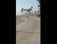 Guy green shirt plunger on head beach