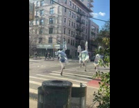 Men Covered in Blanket Plays on Pedestrian Lane