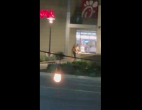 Two women tiktok dance chick-fil-a entrance nighttime