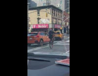 Guy does wheelie on bicycle without front wheel 