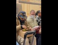 Man prepares weeds while riding the subway