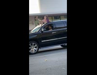two girls black suv sun roof selfies