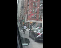 Biker rides with legs on one side 