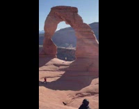 Red leggings girl handstand brown rock arch 