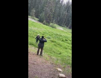 Lady black jacket spins around arms raised 