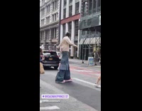 Guy wears stilts under long jeans 