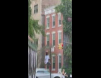 Guy balances basketball while climbing pole 